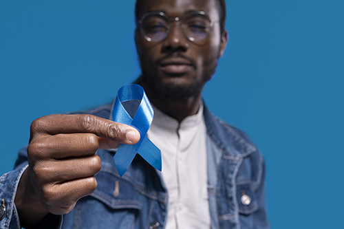 African American Man Holding Blue Ribbon