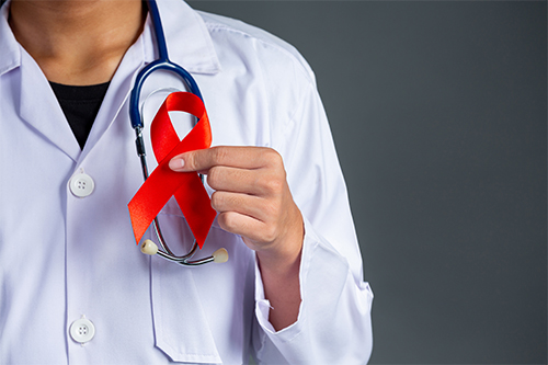 The Doctor Holds A Red Ribbon, HIV Awareness Awareness, World AIDS Day And World Sexual Health Day.